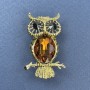 Owl Brooch-Pendant with brown and black crystals, golden metal, diameter 26 mm ±, length 44 mm ±