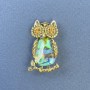 Owl brooch pendant with Haliotis mother-of-pearl, yellow crystals, gold-tone metal, diameter about 18 mm, length about 31 mm