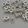 Bail findings, silver-colored metal, dimensions 6×5×10 mm ±, holes 4 mm and 2 mm diameter ±, packaging 20 g (~30 pcs)