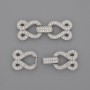 Two-strand clasp with white crystals, 30x12 mm, silver-colored metal