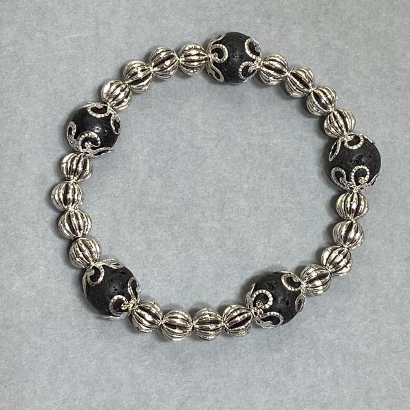 Bracelet with smooth lava beads, 10 mm diameter ±, with metal inserts, length 18 cm ±, stretch