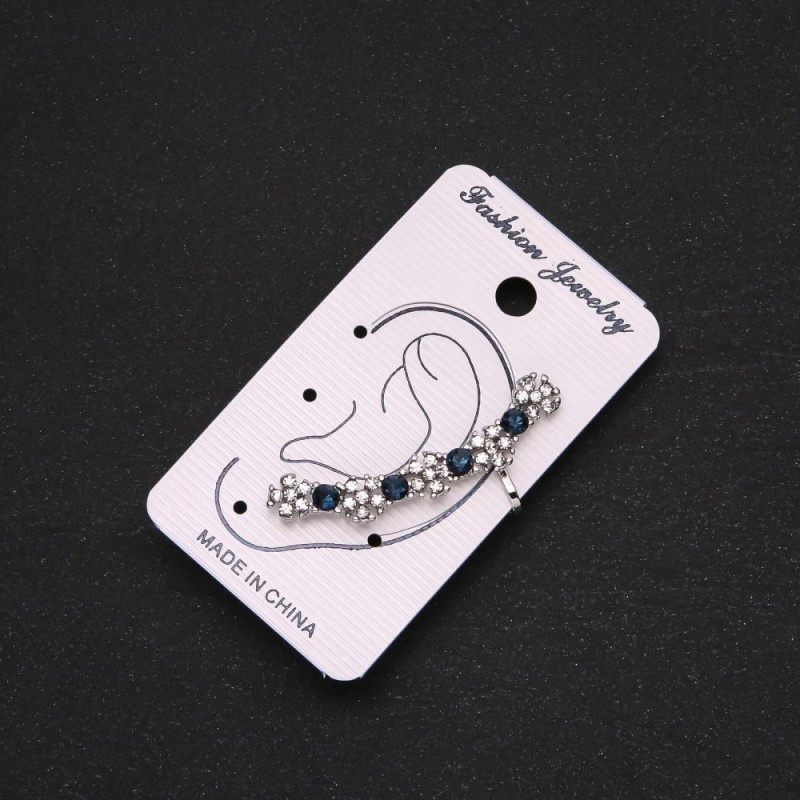 Silver-tone clip-on earring with blue rhinestones and white flowers