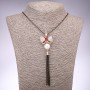 Pendant 'Bow', 29 mm diameter with a red gemstone on a long chain in black gold finish, length 100 cm