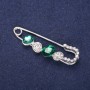 Mini brooch pin with white crystals, green stones, 50x15 mm, silver-colored metal