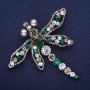 Large dragonfly brooch with rhinestones in green, gray, and white, 65x69 mm, silver-colored metal