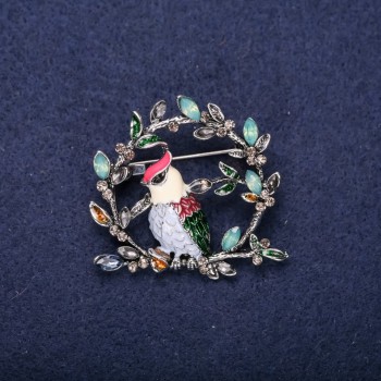 Brooch 'Bird on a Branch' with crystals and enamel, colors red, white, blue, green; 38x40 mm; silver-toned metal