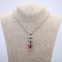 Pendant 'Ball in the Paw', red, 45×17 mm on a chain, length about 70 cm, silver-tone metal