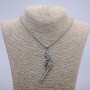 Pendant 'Revolver' 65x25 mm on a chain, length 70 cm, silver-toned metal