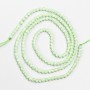 Small synthetic spinel beads, pale green, faceted round beads, 2 mm diameter, on a 37 cm strand