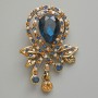 Accent Brooch Pendant with Blue Crystal, blue, white and yellow rhinestones, gold-tone metal 37×46 mm