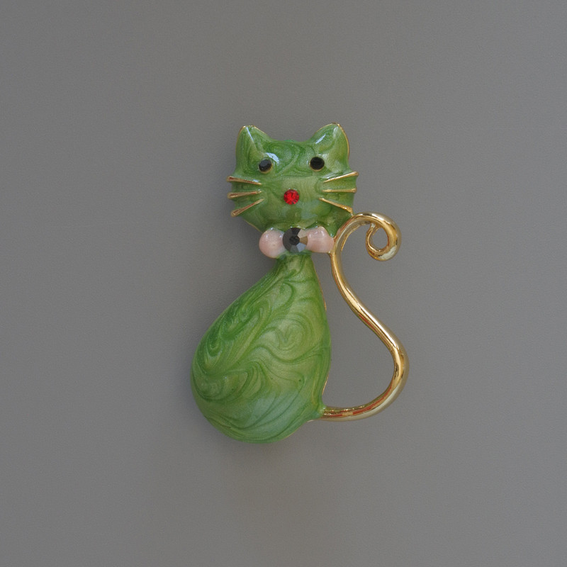 Brooch-pendant "Kitty" with green pearlescent enamel and glittering crystals, gold-tone metal 25x39mm