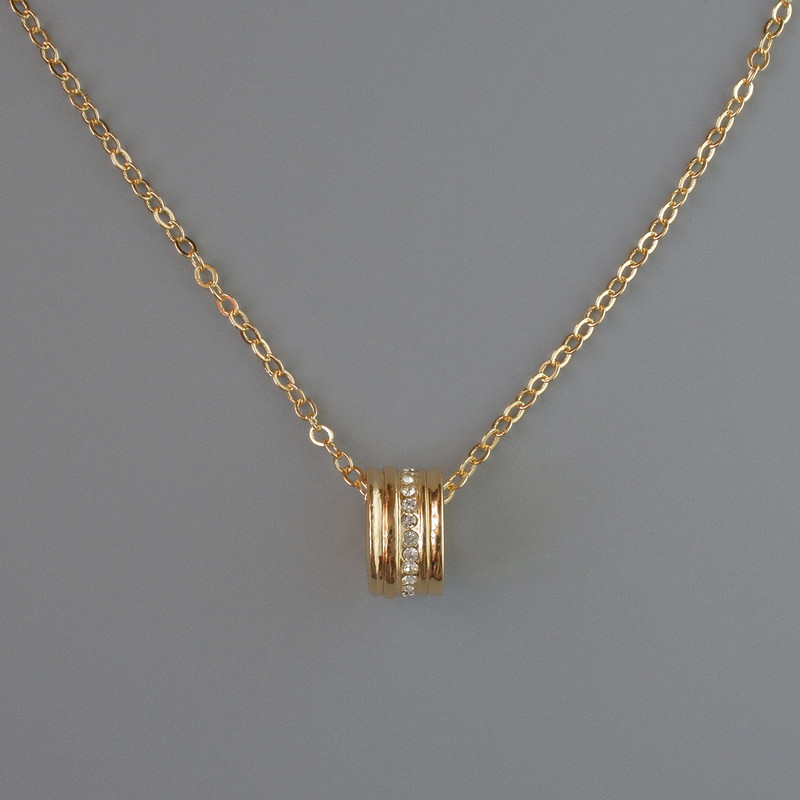 Pendant on a chain, golden metal, diameter 10x6 mm, thickness 1 mm, length 40-45 cm.