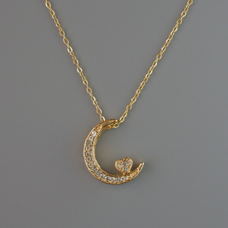 Pendant "Moon" on a gold-toned chain, diameter 18x14 mm, thickness 1 mm + -, length 40–45 cm +