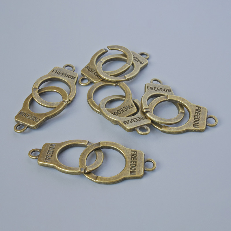 Pendant finding 'Handcuffs', diameter 23x14 mm, thickness 5 mm, hole diameter 2.4 mm, length 40 mm, pack of 5, bronze metal color