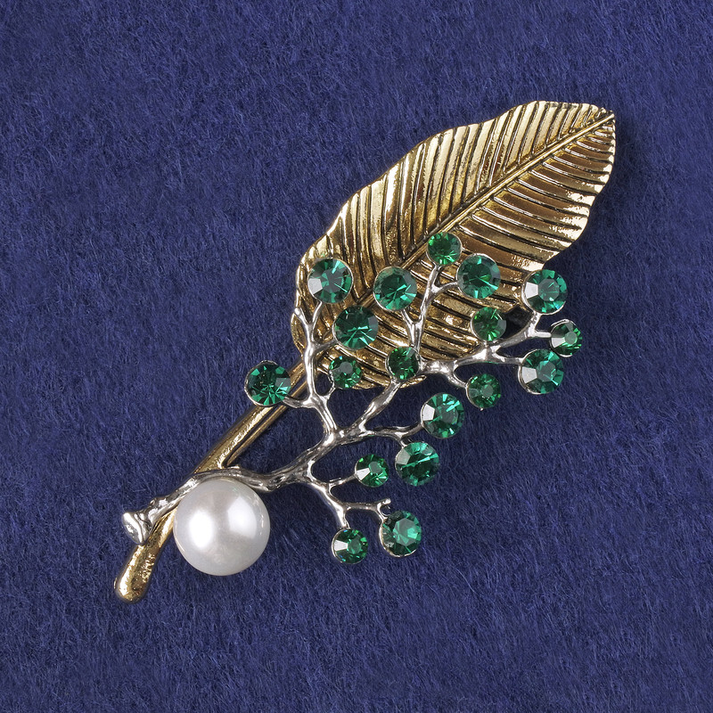 Brooch-pendant Sprig with green crystals, white bead, gold-tone and silver-tone metal 76x33mm+