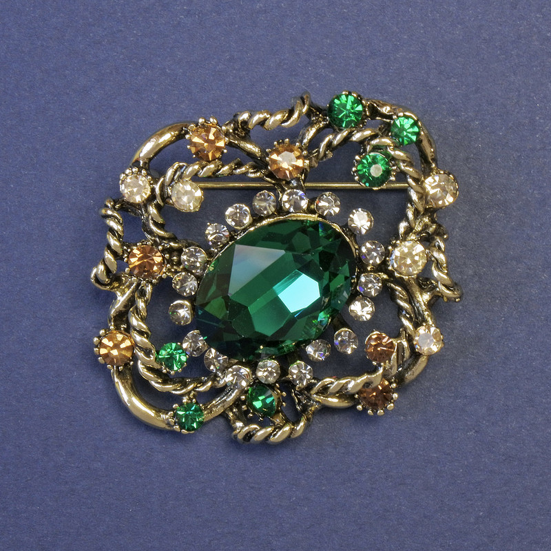 Accent Brooch with a Large Green Crystal and Crystals, 44x38 mm ± Gold-Tone Metal