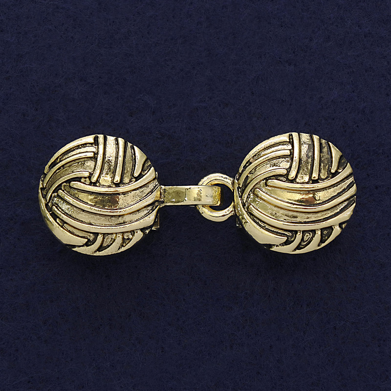 Gold-tone cardigan brooch clasp, approximately 20 mm in diameter and 52 mm long