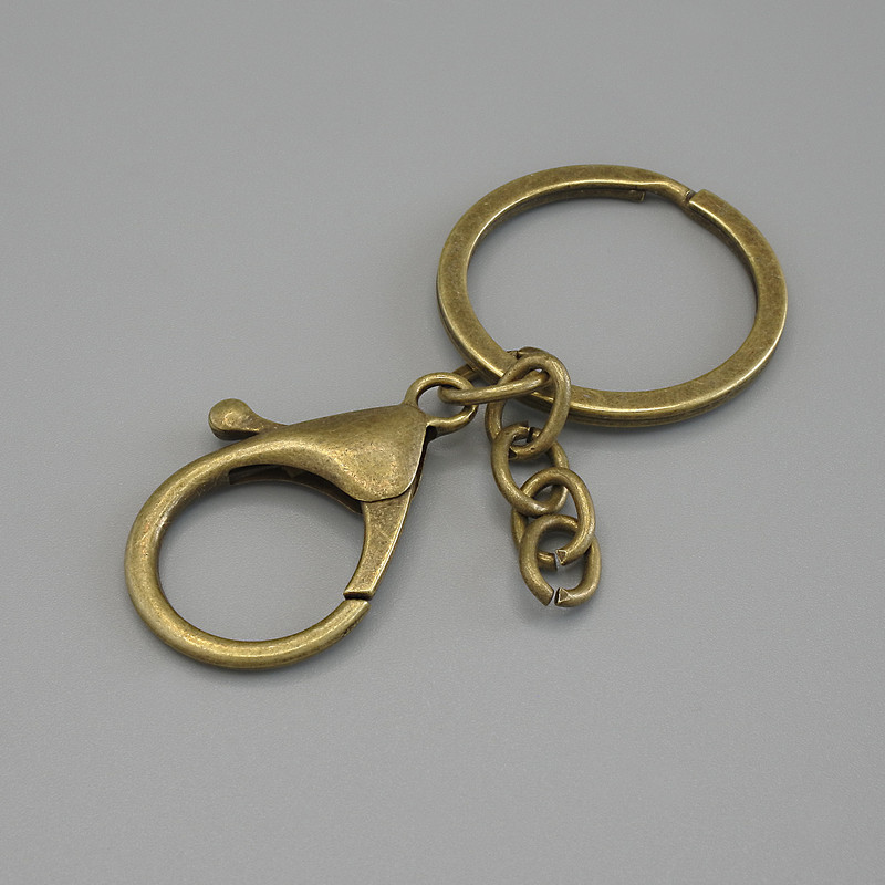 Price per pack /10 pcs. Base for keychain with two attachments: carabiner 33×24 mm and ring, diameter 3 cm, length 7 cm