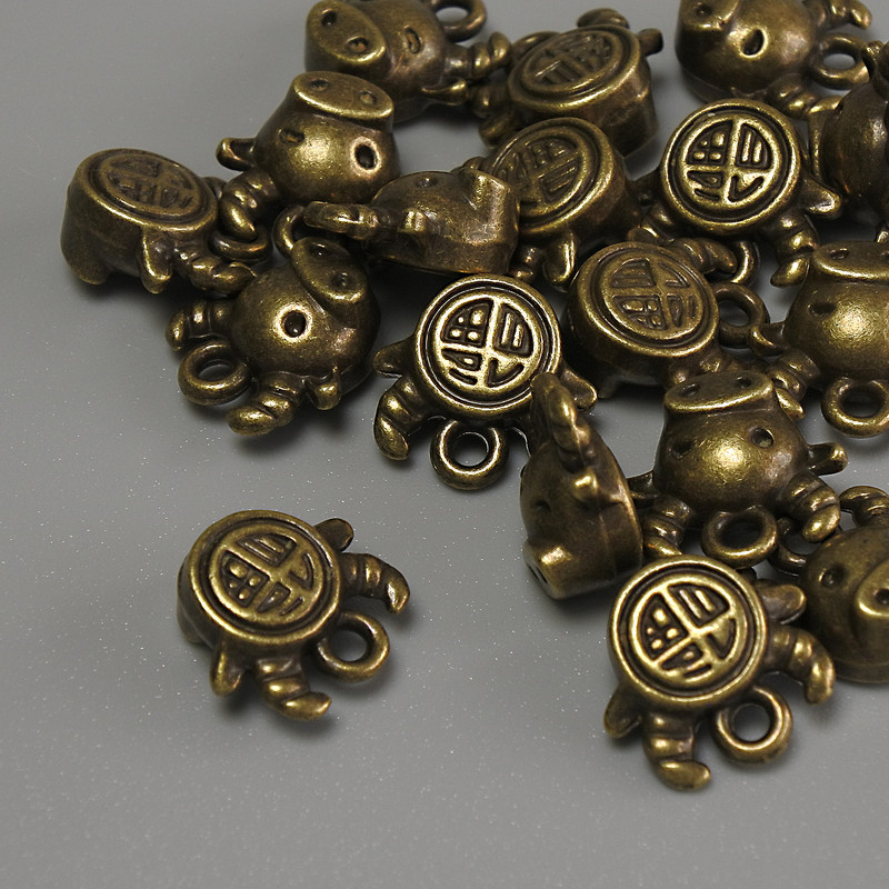 Bull pendant finding, bronze metal color, size 10x9x5 mm, hole diameter 1 mm, packaging 20 g (~17 pcs)