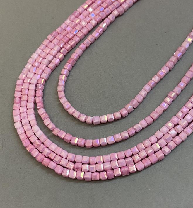 Pink Czech Crystal Beads with a 'Gasoline' finish on thread, faceted cube, diameter 4x4 mm + -, length 38 cm +