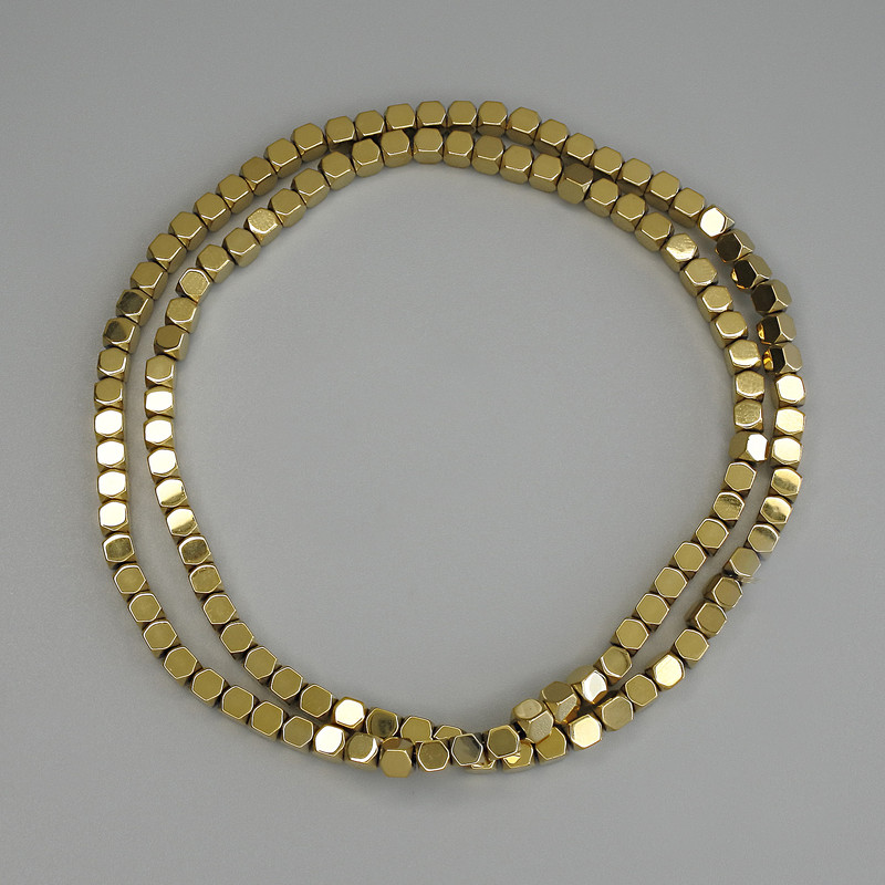 Gold-colored hematite beads, cube-shaped 4x4 mm, on beading wire, length 40 cm+