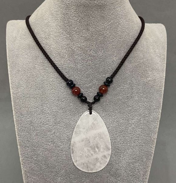 Teardrop pendant with white quartz 55x35mm (+-) on a cord with a carnelian bead, 65 cm long+
