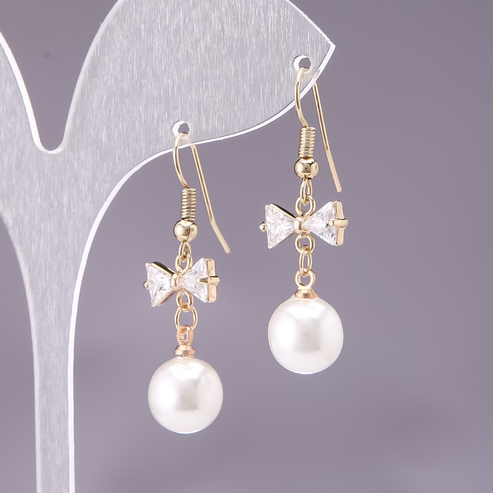 Earrings 'Bows' with White Beads, diameter 10 mm, length 3 cm, yellow metal