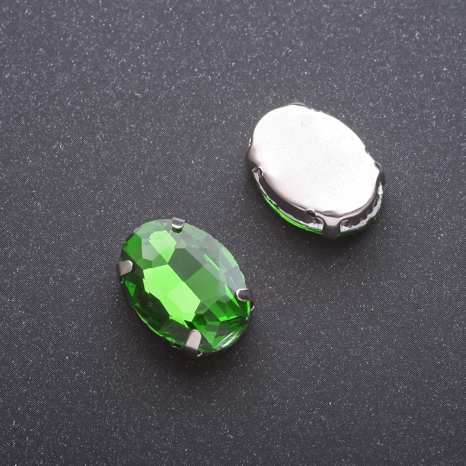 Price per pack / 10 pcs. Sew-on crystal in cap setting oval 13×18 mm green
