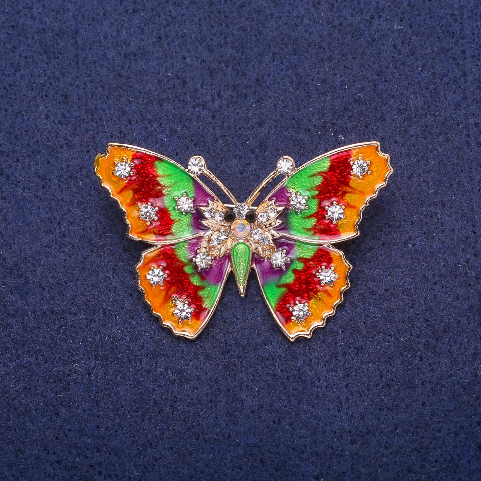 Brooch 'Butterfly' with red and green enamel on yellow metal