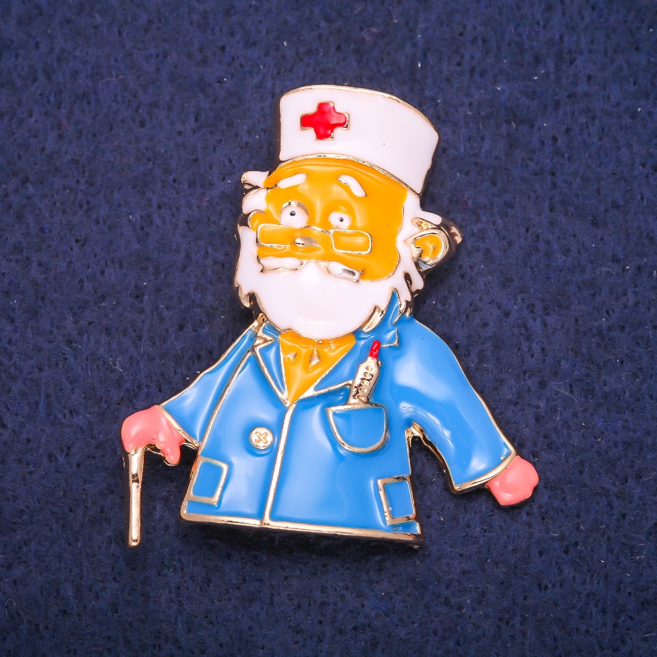 Brooch 'Doctor' enamel white and blue, 47×42 mm, gold-tone metal