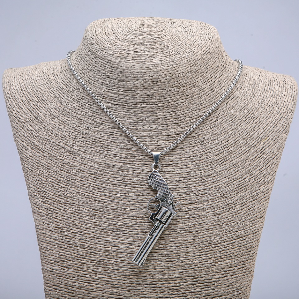 Pendant 'Revolver' 65x25 mm on a chain, length 70 cm, silver-toned metal