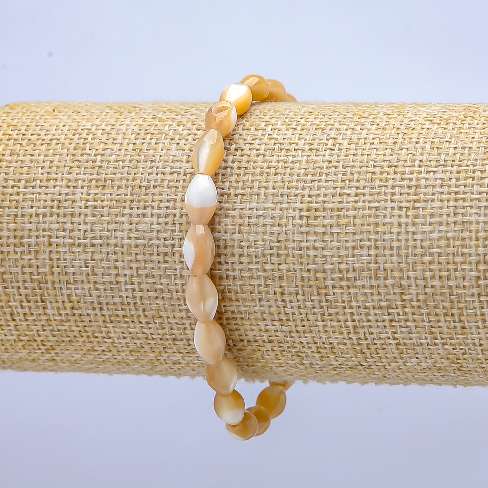 Elastic bracelet with natural beige mother-of-pearl. Oval, 10x6 mm, 5 mm, length 18 cm