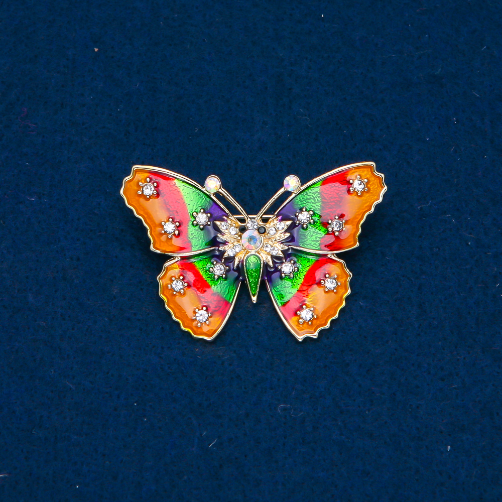 Butterfly Brooch in gold-tone metal, enamel, and white iridescent rhinestones, 30x44mm