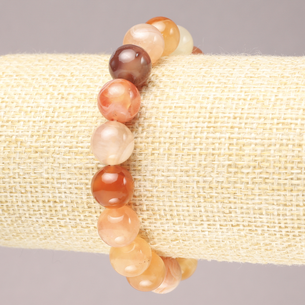 Elastic bracelet made of natural orange agate. Smooth bead, diameter 10.5 mm+