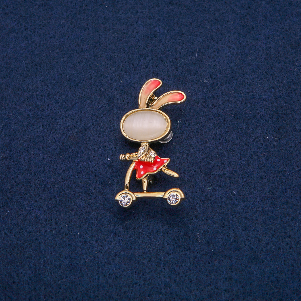 Brooch 'Bunny on a Scooter' with white crystals, gold-tone metal, red enamel, Cat's Eye cabochon (bijou) 43x21mm +