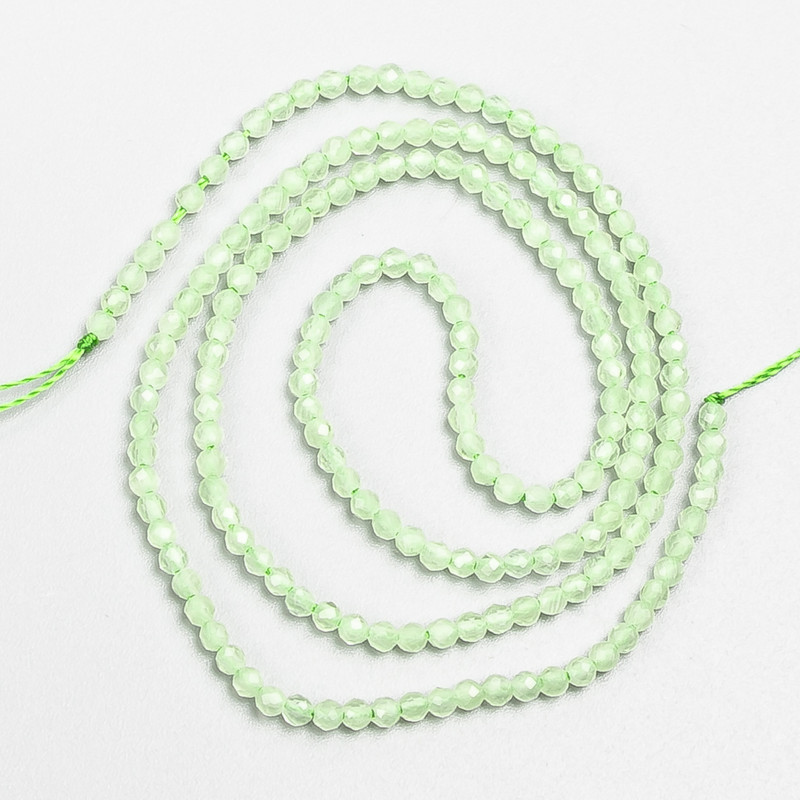 Small synthetic spinel beads, pale green, faceted round beads, 2 mm diameter, on a 37 cm strand
